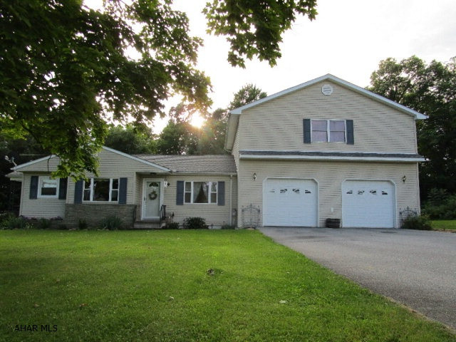 Super well maintained split level home resting on 2.214 acres!!  This home has been nicely updated and offers a living room, eat-in kitchen with custom oak cabinets, main level laundry room, two full baths and three bedrooms.  Heat pump with central air-conditioning, wood burning furnace & 200-amp electric.  Large 28' x 30' garage, new patio with pergola, nicely landscaped and large yard for roaming.  Scenic country views, level lot is open and wooded & convenient location.  This is a really nice property!!