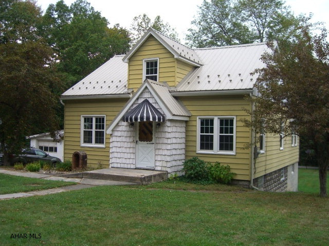 This lovely Cape Cod home is situated on a large private lot between state game lands and is only 5 miles from Prince Gallitzin State Park. It offers a newly remodeled large master bedroom with a walk in closet on the first floor and two spacious bedrooms on the second floor along with a den/office. There have been many improvements and updates made to this home to include a totally redone bathroom, updated wiring (200 amp) and thermo pane double hung windows with a transferable warranty. The exterior is maintenance free with a metal roof, siding and capped window trim. There is plenty of parking and a large two car garage.  Call for an appointment today.