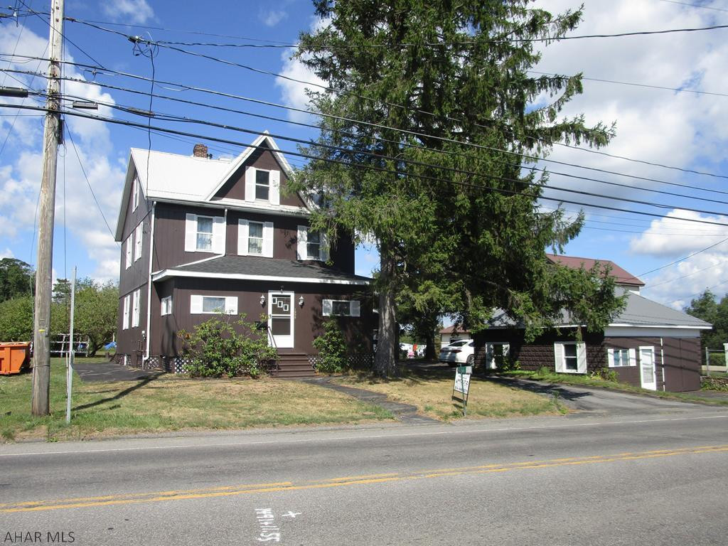 Two story home featuring 4 bedrooms, cherry kitchen, large living room, den that could be used as a 1st floor bedroom and 1.5 baths. Nice attic storage. Two heating systems - coal and oil.   Shop building (was rented at one time), two car detached garage with paved drive, ab gd  pool in enclosed building with outdoor furnace to heat it, and a storage building. Nice grounds including many fruit trees (peach, apple, pear and blueberry).