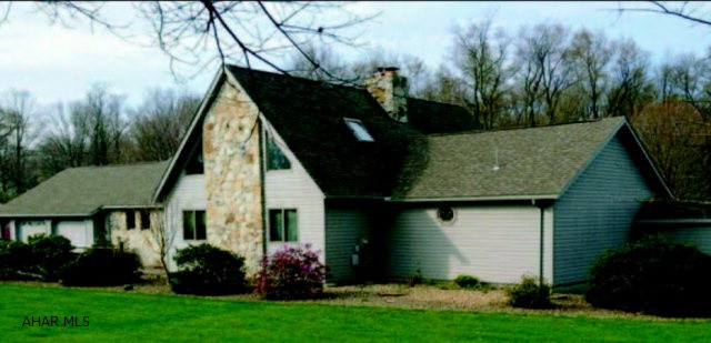 Beautiful 3+ Bedroom Ranch style open floor plan, home, 6.3 acres. 2 car attach garage. Real field stone fireplace with pellet insert in sunkin living room with cathedral ceiling with three oak beams. Large loft overlooking the living room. Oak flooring in dining area and oak trim throughout the home.  Full finished basement with fourth bedroom, living room, wet bar, brick fireplace with pellet insert and 3/4 bath, with outside entrance.  Outside covered pavillion with electric and water, cable and phone and fireplace. Small wood garden/ utitliy shed.  Brick paver patio and sidewalks. Beautiful river rock landscaping throughout the yard. 30X40 pole barn with all utilities, coal/wood burner, fully insulated and finished interior, hold two plus vehicles. Five zone hot water baseboard heat.