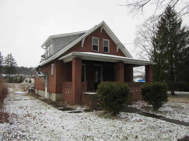 Brick cape cod style house, spacious rooms, wood floors, lots of potential