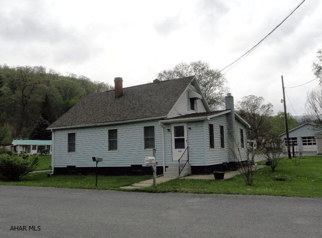 One and a half story home in Mill Run area. 1/2 acre with 30'x28' three bay heated garage. Vinyl siding. Hadicapped bathroom. Logan Twp. 2 BR. Could have business use. Handicap access. Large paved parking area.