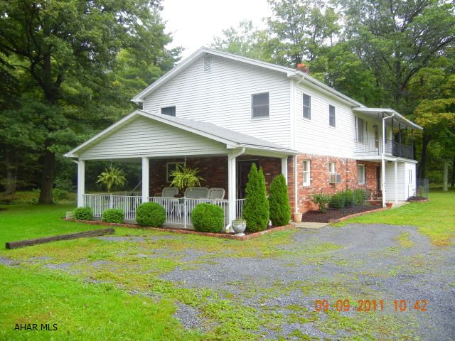 Property in quiet, secluded area. 4 bedrooms and 2 complete kitchens, eat-in kitchen, dining room, living room w/wood stove, 1 stall attached garage. One full bath & one half bath. Property boarders trout stream & adjacent to state game lands.  Call Dan Laratonda.