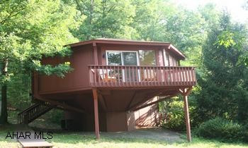 Fantastic home in the woods! Fantastic home in the woods! Contemporary octagon-shaped house with lots of windows to bring the outside in. Nestled amongst the trees; great location, across from Bedford Springs Resort golf course. Open floorplan, kitchen, dining area, living room, 2BR/2BA on main level. Spiral staircase leads to lower level family room. New windows, heat pump, roof, floor coverings. Peftect for a second home or someone who wants low maintenance. Relax and enjoy the outdoors on one of the decks.