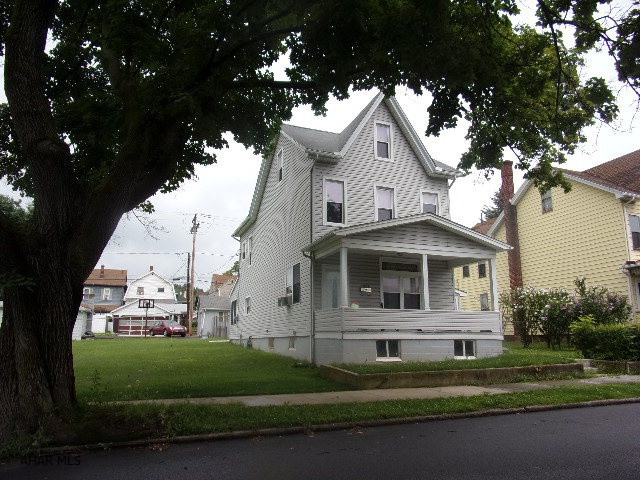 Lots of room, inside and out!  3 or 4 bedrooms, first floor laundry and finished attic.  Replacement windows and vinyl siding.  Nice sunroom off kitchen.  Two detached garages, 1-car with storage, and a 2-car detached.  Garden area and partially fenced lot, along with off-street parking.  Lots of bang for the buck!