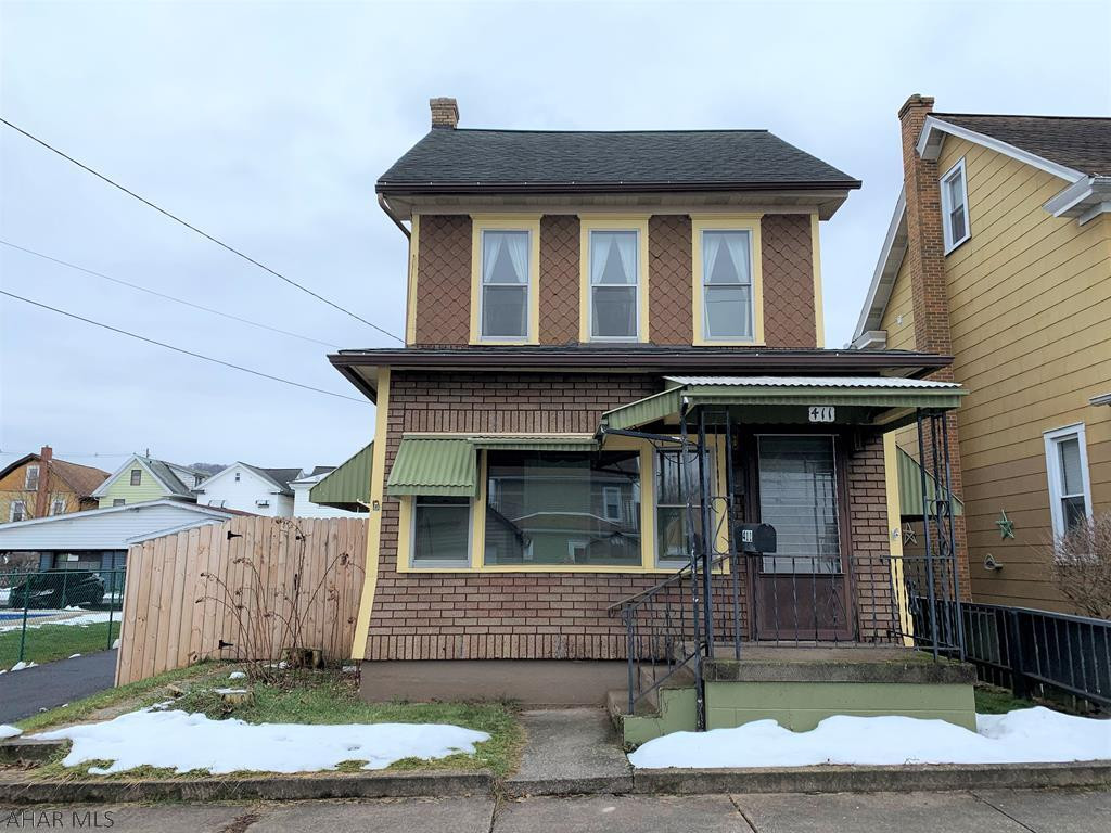 Affordable two-bedroom charmer in the Tyrone borough!  Upon entering, you will appreciate the bright heated sunroom with newer flooring while the living and dining rooms feature high ceilings and original hardwood floors.  The bathroom was recently updated and both bedrooms have good storage/closet space.  The walk-up attic provides an extra living space, perhaps a home office or playroom.  Outside, the privacy fence and covered back deck create a comfortable place to relax in warmer months. Updated electric (2016), furnace is newer (2016), refrigerator (2017), countertop dishwasher (2020).  Garage/workshop being sold as-is.