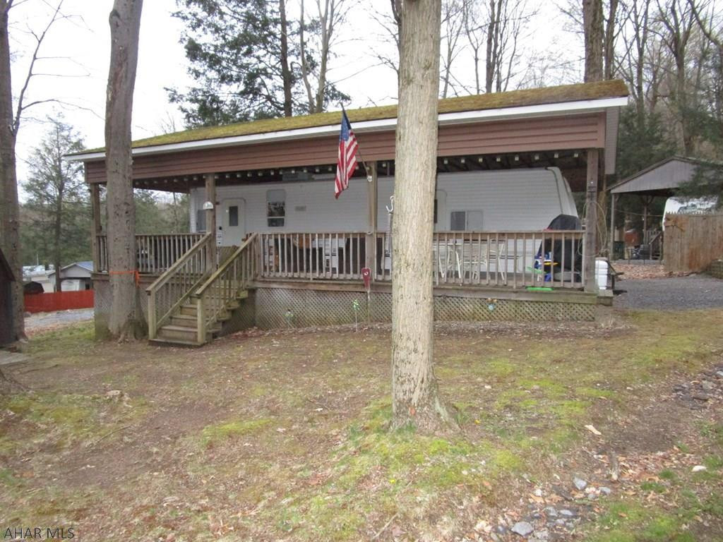 Nice roomy camper with slide-out for more space.  Pavilion covering for protection of your camper along with covering the spacious deck for additional outdoor space.  Sets back for privacy.  Located in Glendale Yearound, a gated recreational community adjacent to Prince Gallitzin State Park / Glendale Lake.