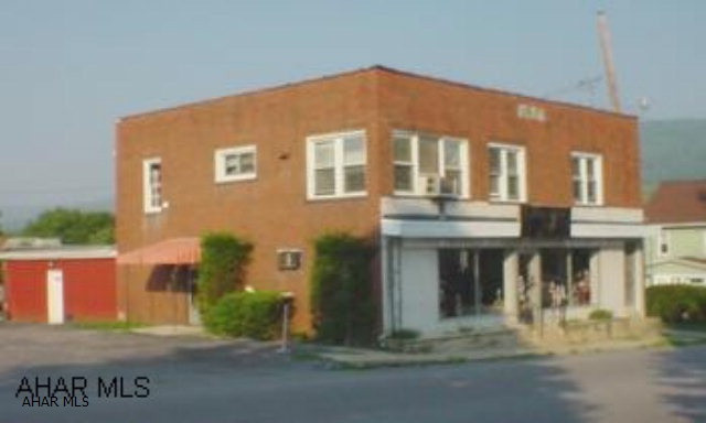 2 story brick building with parking lot. 1st floor is approx. 1700 sq. ft. and includes retail space, 2 offices spaces & large storage area. 2nd floor has a 2 bedroom, 1 bath apartment with new carpet, ceramic tile, new oven, washer/dryer hook-ups, & all new windows. Main roof is rubber, approx. 13 years old and rubber roof over storage area approx. 2 years old. Agent is related to seller.