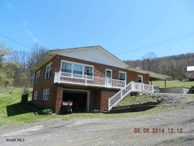 This brick home is situated on 2.8 acres. main house has new windows ,new roof,new bath and new hot water heater. Large wrap around back porch with a fireplace or can be used as a car port. a two car garage.  a Barn. Great horse property.