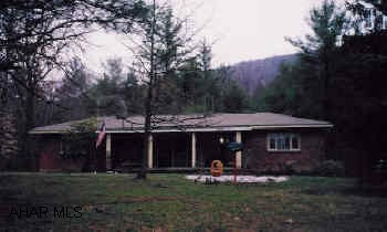 Nice 3 BR brick home situated on 3.125 wooded acres with large pond.