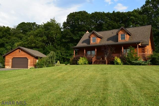 This beautiful log home is made of whole southern yellow pine logs and situated on a 3.57 acres with terrific views of the mountains across the valley. The stone fireplace extends all the way to the peak of the magnificent great room. The master bedroom is conveniently located on the main level with a jetted tub in the four piece en suite bath. Enjoy the morning sun on the rear deck and sunsets over of the mountain from the covered front porch. Enjoy spending time at your beautifully landscaped fish pond or your back yard fire pit. The full basement has been framed and studded.There is also another 3.57 acres adjoining the property available which has been perked for three lots and each having access points approved by PenDOT. Call listing agent for more details or a private showing.