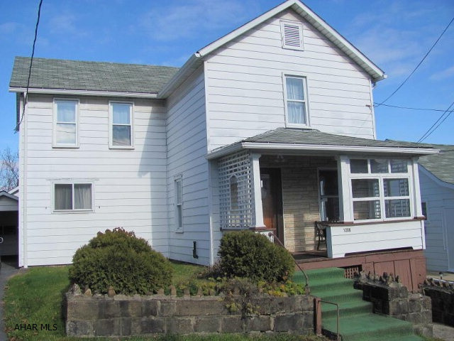 2 story aluminum sided 4 BR home on a 43 x 125 lot. Gas hot water radiator heat. 1 car detached garage & carport.