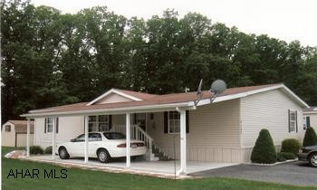 Immaculate 1998, one owner doublewide on rented lot. Inviting open floor plan in this 1998 doublewide. Kitchen has lots of oak cabinets, a pass thru eat -at counter, plus kitchen appliances included. As an added bonus the washer and dryer are also included. Easy care landscaping with a shed. Lot rent is $200 a month which includes garbage.  Settlement is contingent on sellers property settlement at Homewood.