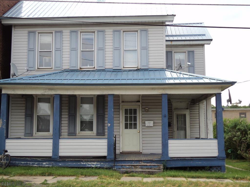 Duplex with fenced backyard, large two car garage accessed off paved alley at rear of garage.  Property is being sold in it's present "AS IS" condition.  Stove refrigerator and microwave in Unit No 1 included large deck off rear of Unit No. 1.  Stove & Refrigerator in Unit No 2 included.  Seller will make no repairs before or after sale. Located within easy walking distance of stores & restaurants. Good income potential.