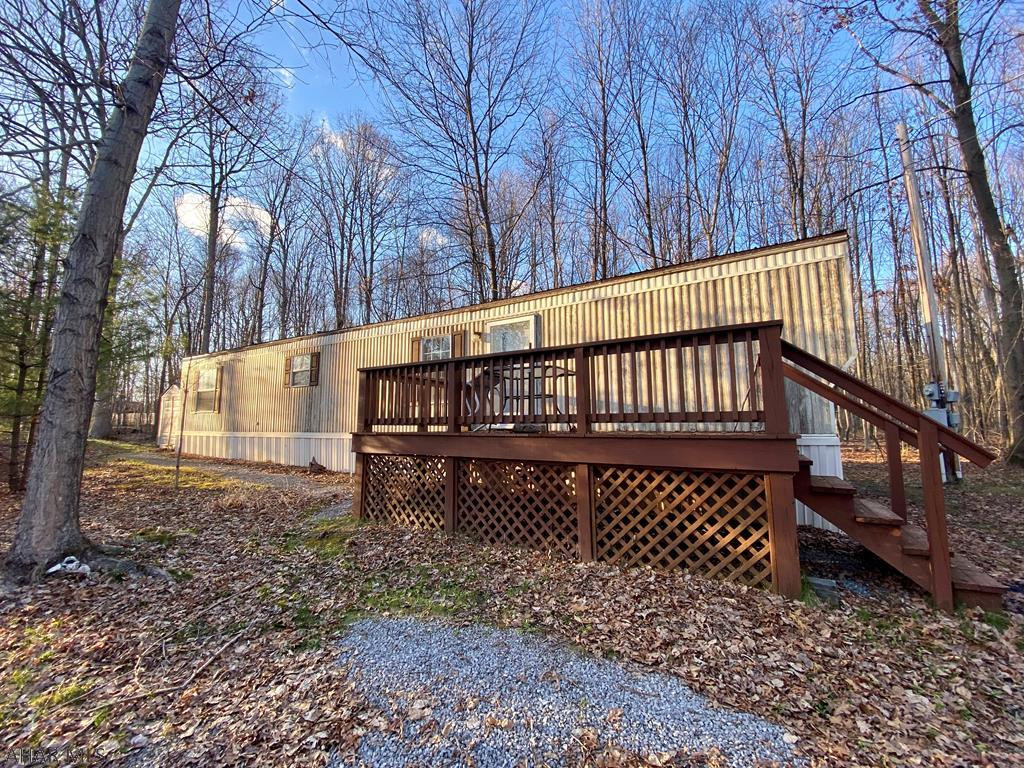 Welcome to an affordable opportunity to enjoy all Raystown Country has to offer.  This 2 BR, 1 BA immaculate mobile home is situated on 1.24 owned acres in the Dun Rovin Subdivision.  For the hunter at heart, it is located within walking distance to State Game Lands.  If you enjoy boating, hiking, and biking, it is a short drive to Raystown Lake.  This home comes completely furnished and is ready for you to enjoy the peace and tranquility of country life as a vacation retreat or permanent residence nestled among the trees.