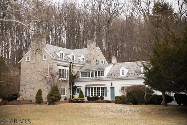 Exquisite home overlooking and abutting the Bedford Elks Golf course, within minutes to the Omni Hotel. Stone faade w/ a slate roof, outside patio w/ an outside fireplace. 3 floors of living space, includes 7 fireplaces and 6 bathrooms. Hardwood floors in the 3rd floor bedrooms; under the carpets on the second floor. Large rooms, original house plans available. Kitchen on the 1st and 2nd floor for hosting parties or large family gatherings. Formal dining room w/ fireplace on 1st floor w/ 2 French doors leading out to the patio. 3 bedrooms all w/ private baths & fireplaces. Front / back staircase, deep window sills, lots of storage space. 2 car attached garage w/ heat and water, paved wraparound driveway and small barn. Truly one of Bedford's most Majestic Homes!