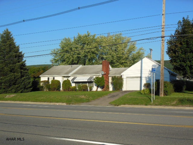 REDUCED!!  Centrally located Ranch home by BG and VA Hospital. 2 BR, 1.5 bath, 2 car attached garage, newer furnace, 200 amp breaker box, large corner fenced lot on Pleasant Valley Blvd and 26th St. with some privacy in the back. Good parking that can be expanded, and appliances included. Zoned residential but a location around some other businesses - may be variance?  One floor living with laundry on the 1st floor.  Large Living room with wood burning fireplace that is used in winters for enjoyment and heat.  Hardwood floors, ceramic tile floor in kitchen, plenty of off-street parking in rear. Worth a look!! (Built on rock, and that is why it has a partial basement with good crawl spaces...)  Handy to shopping and more!!  Reasonable offer considered!!