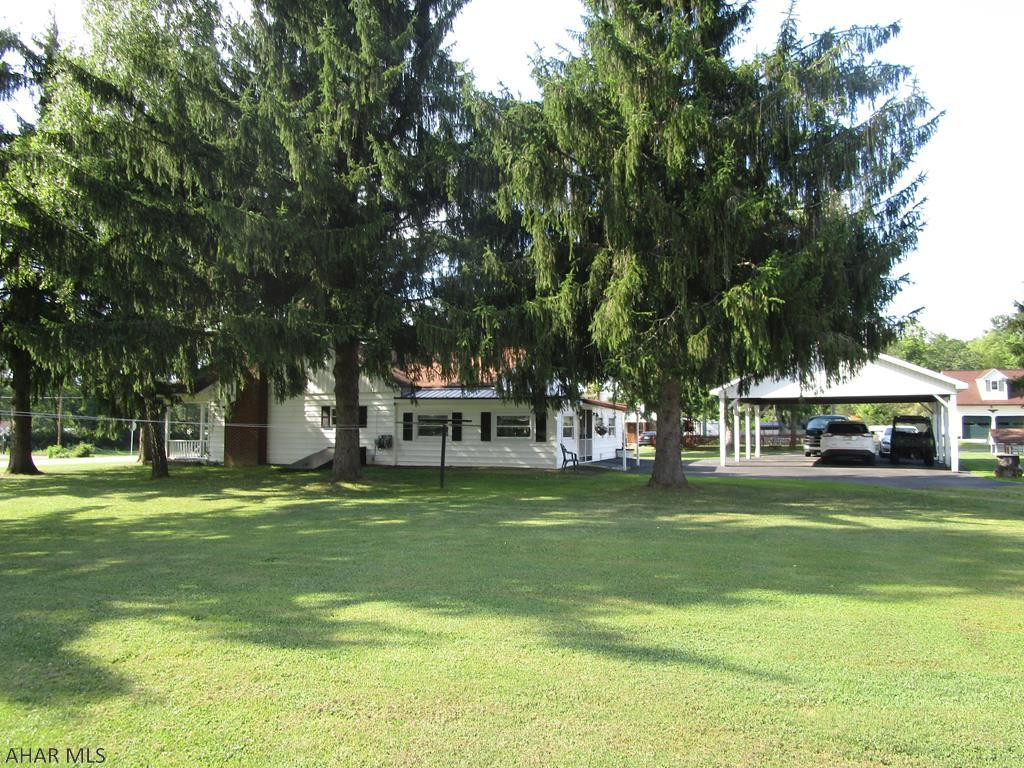 1.5 story 3 bedroom 1.75 bath home on a large level lot. Home includes family room addition and living room with fireplace, nice kitchen with oak cabinets.  Guest /entertainment log house included in good condition. 4 car carport with paved parking area. Inground fenced in pool. A great home for the $$.
