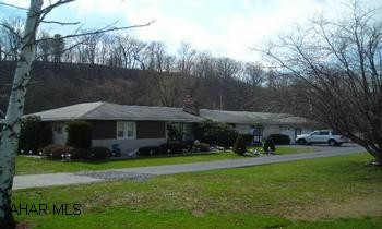 Sprawling ranch that has been lovingly maintained on 4+ acres! This large ranch has been lovingly maintained and offers 1600+ square feet, 3 bedrooms, 1.5 bath, office, large laundry room, eat-in kitchen, spacious livingroom with fireplace, rec room, screened-in porch, attached 2 car garage!  Terrific setting with Yellowcreek in backyard!  This is a must see home! AGENTS- call Tina to show at 814.242.2047 OR 814.623-3295;5% total commission with reciprocal split first 30 days and 6% total commission thereafter with reciprocal split.