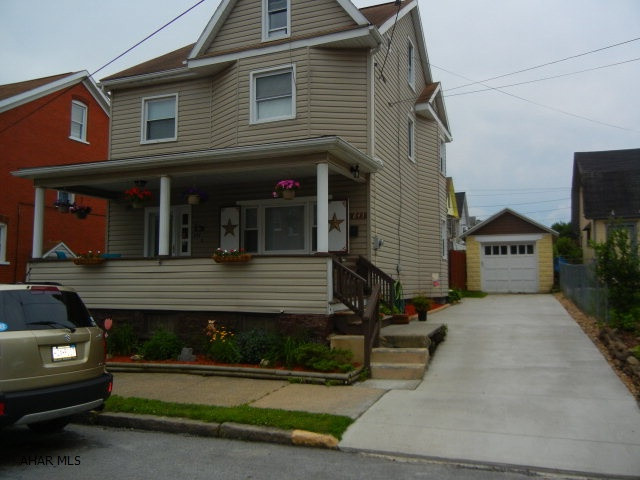 Nicely updated home with private backyard.  Newly fenced area for small children or pets off covered back porch.  Remodeled kitchen allows easy access to formal dining room.  New concrete driveway to garage at rear of property.  Open front porch.  Finished third floor for additional bedroom, office or children's playroom.  Many newly replaced windows throughout.  HOME WARRANTY INCLUDED.