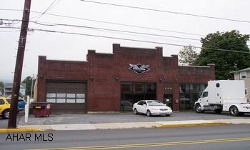 Concrete block building w/ unique front brick facade. Newer metal roof, concret floor, overhead doors in front and back of structure. Completely rewired, new oil hot water heating system w/ 2 boilers/ taco zone relay, 30 bags blown-in insulation in attic (R-24). Current tenant is on month-to-month lease.