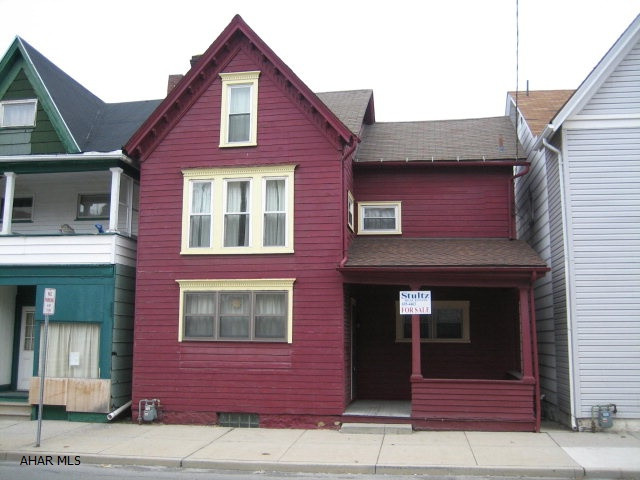2 1/2 story home, 3 bedrooms, 2 baths. Living room with stone fireplace. Dining room, Den, Hardwood floors, updated windows. Third floor could be extra living space.