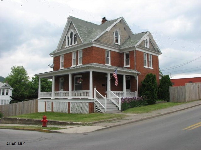 Charming Brick Home.  Tastefully redone throughout.  New Hardwood, Flooring, Trim & Crown Moulding.  Brand new beautiful cabinets and counter-tops.  Warm paint color and new light fixtures.  Very Spacious with clean basement.  Large unfinished attic.  Tremendous fenced yard and off street parking.