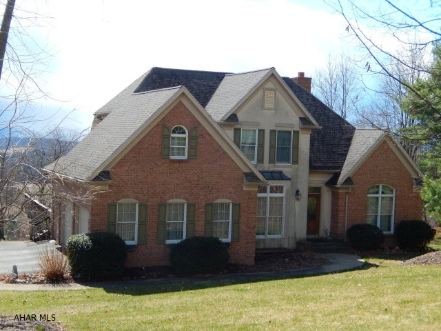 Incredible view, wrap around deck w/retractable awning, vaulted ceilings with skylights,stone fireplace(wood burning),HW floors,1st floor master suite,custom cabinets in kitchen, geothermal heat pump w/ C/A, covered gutters.