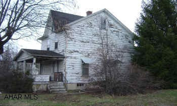 2 story frame home, old condition. Zoned business. Home is a fixer upper. Creek runs through rear of site. Has overflowed. Is currently ok. Call office for details.