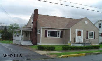 Sold As Is. 1 1/2 story vinyl siding, full basement with walkout, brick fireplace, and on a level corner lot.