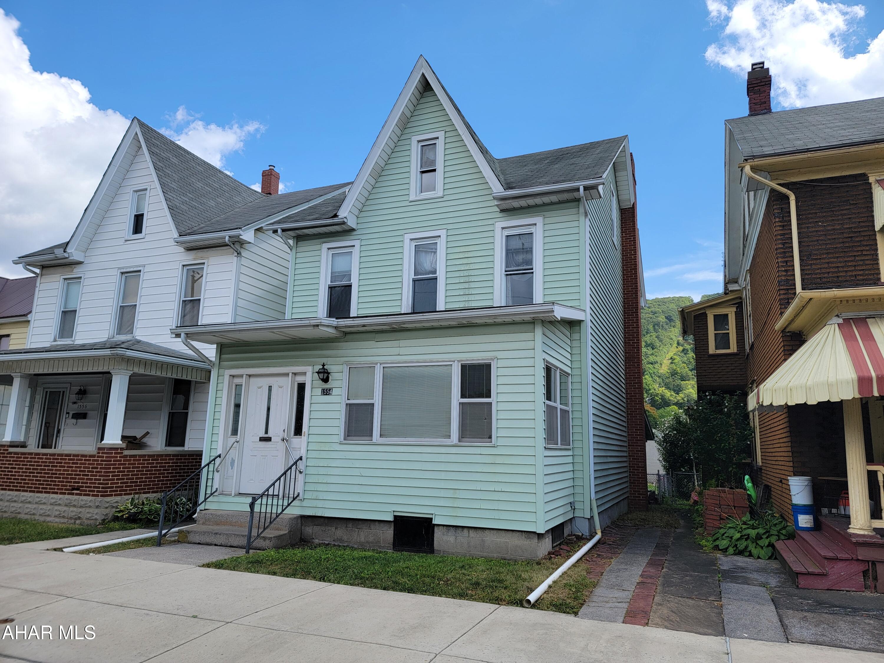2 1/2 story, 4 bedroom home with 3 baths. Two bedrooms on 2nd floor and two bedrooms in heated 3rd floor. Brick fireplace in dining room. Hardwood floors. Multi-fuel (Gas/Coal/Wood) hot water heating system. 1st floor sunroom and mud room. Covered rear patio. 2 car detached garage.