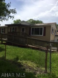 Double wide on foundation with full unfinished basement with 2 car garage. Very nice large level lot. Will need a roof and inside painting to make this a great one floor home.