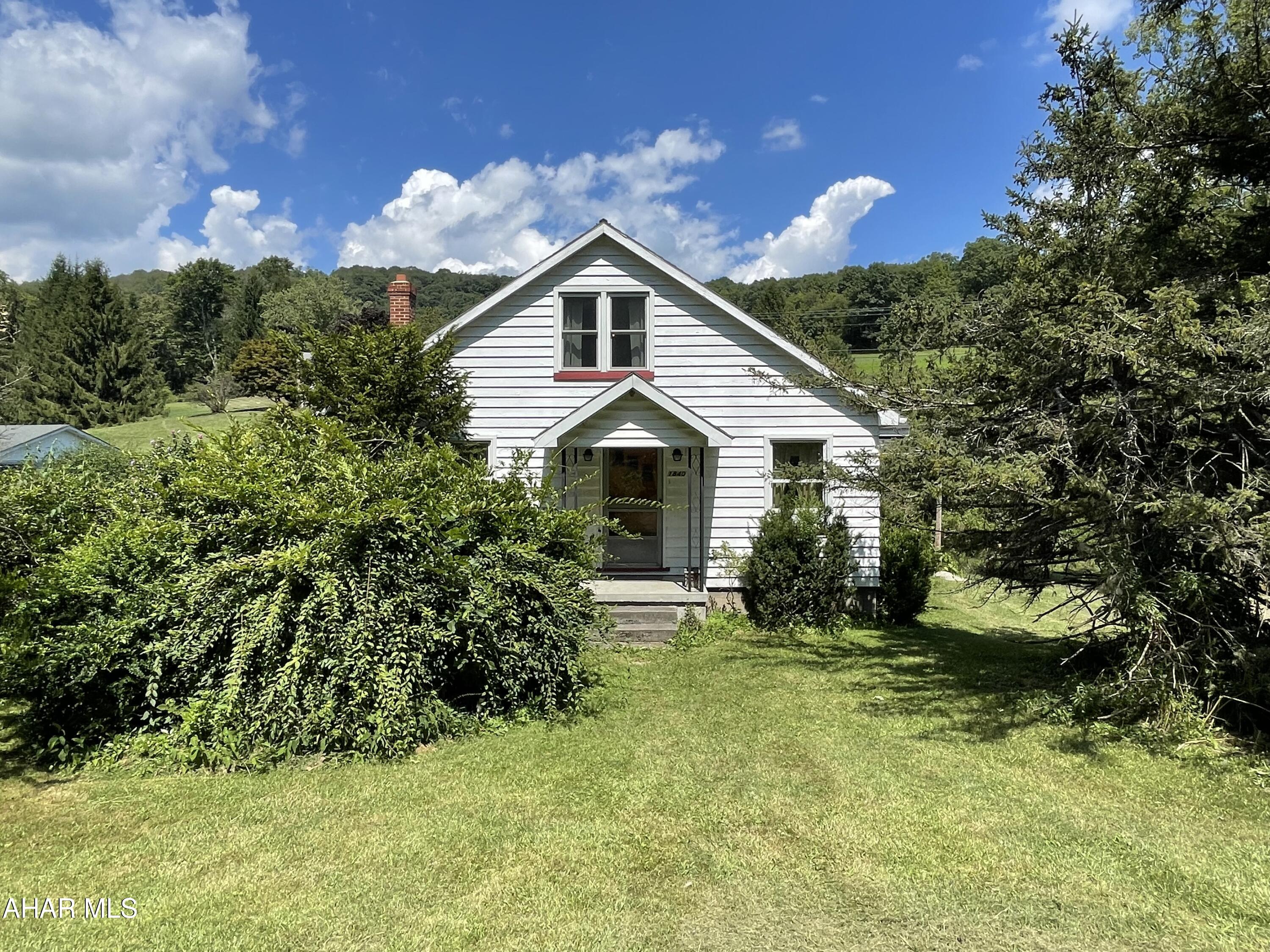 Location location location.... Have you been looking for country living... a place outside of town where you can have chickens, goats or possibly horses in the Hollidaysburg School District?  Then this home sitting on 5.8 acres with a separate garage and a bank barn is the one you will want to see!  This 4 bedroom 1 bath home is larger than it looks.  It is bright and airy as the windows let the natural sun light in from all angles.  First floor you have an eat in kitchen living room 2 bedrooms and a full bath.  Second floor there are 2 bedrooms.  The basement has connections for an additional half bath.  Plenty of space to roam around outside on this property, want a garden you can have a massive one... want a zip line... you could do that too.  There are endless possibilities. Over sized one car garage that can fit your vehicle and other outdoor tools and accessories.  The bank barn has two stalls in lower level.  Small stream runs through the valley during the wet season.  Call today for additional information.