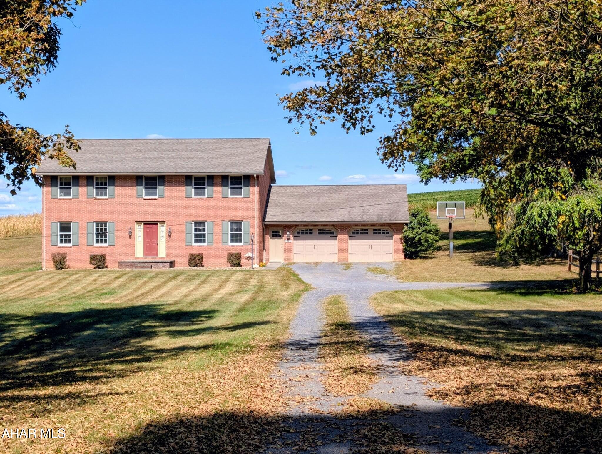 Welcome to Country Living!
Nestled on 3.316 scenic acres in beautiful Bedford County, this charming two-story home offers the best of rural living with all the space and privacy you've been dreaming of. On your way, you'll pass the renowned Boyer Orchard—a local favorite—setting the tone for the peaceful lifestyle that awaits.
With over 2,400 square feet of living space, this home is perfect for hosting family gatherings and holidays. Whether you're inviting the in-laws or enjoying a quiet retreat, there's room for everyone—without sacrificing your privacy.
Out front, a basketball hoop invites fun and friendly competition, while the inground heated hopper pool offers the perfect way to relax after a long day.
Inside, you'll find a warm and inviting layout. The first floor features: A half bath,
a mudroom that could double as a small office or study, a gathering room complete with a charming brick fireplace.
The country-style kitchen is a true showstopper, featuring custom cherry cabinets crafted from wood sourced directly from the property. Granite countertops and a farmhouse sink complete the rustic elegance, making this kitchen the heart of the home.
Enjoy sit-down meals in the formal dining room, or unwind in the living room highlighted by a unique stained glass window that adds character and charm.
Upstairs, you'll find: Three spacious bedrooms, including a primary suite, a full bath, ready for your personal touch with a few minor updates. Newer wall-to-wall carpet for a fresh and cozy feel. 
Stay warm all winter long with radiant heat that provides consistent comfort throughout the home.
Outside, the possibilities are endless. With over 3 acres of open land, you have the space to: Tinker or work on hobbies in the garage, keep animals in the stable located at the corner of the property, or simply enjoy the privacy and peaceful surroundings.
This home is the epitome of country living—peaceful, private, and full of charm. It truly must be seen to be appreciated.