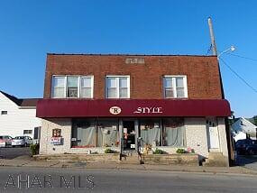 Looking to start your own business?  Brick commercial building with 11 parking spaces with high traffic count. First floor is a very large room and 2 smaller rooms.  Basement area is spacious & partially finished. The 3rd floor is quite large with 2-3 bedrooms, 1 bath apartment that is very nice.  Long term tenants pay $800/month. Approx. square footage is 5,200 for the entire building including the basement.