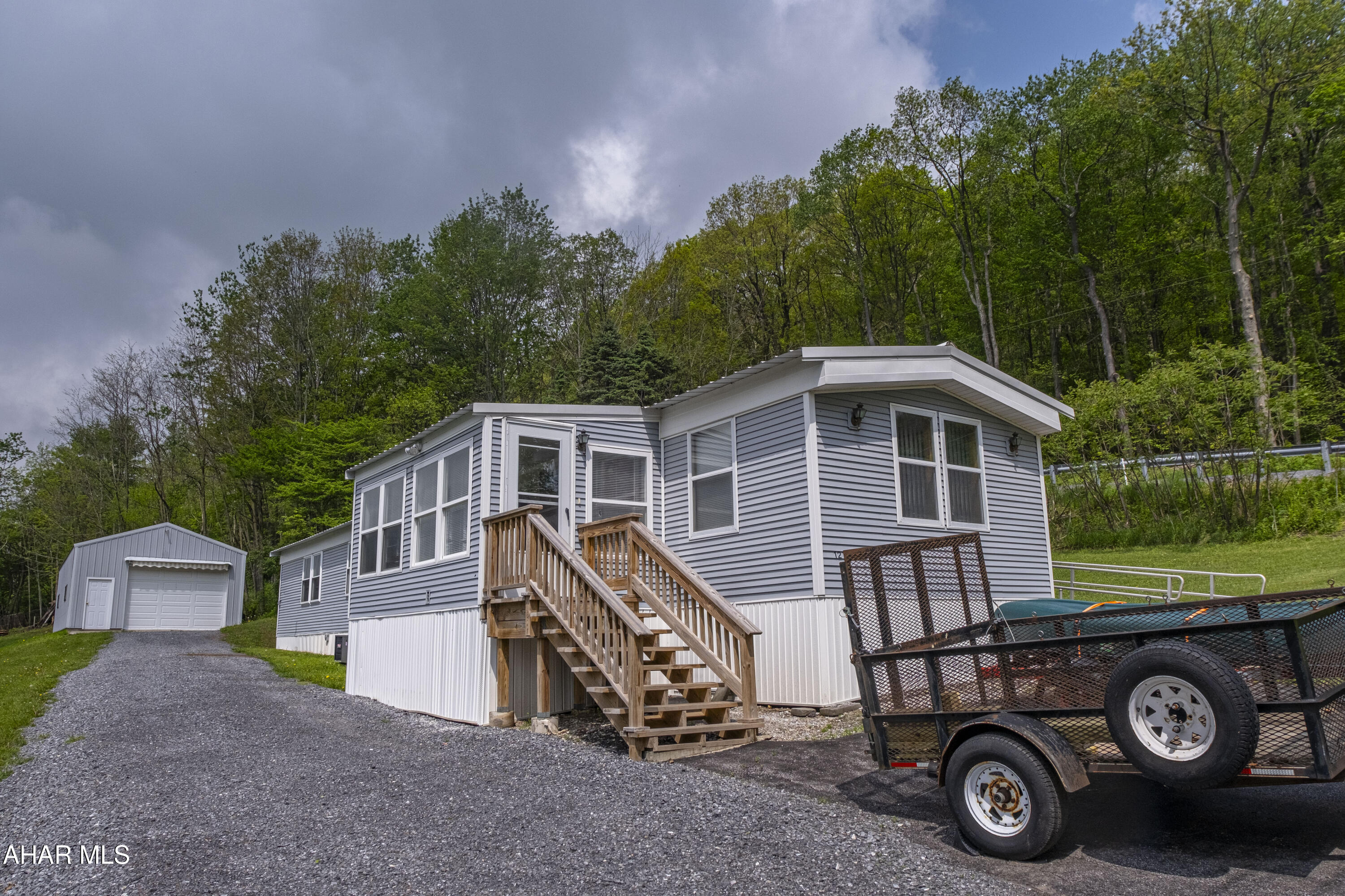 A well-maintained 14x68 mobile home  permanently set on a spacious 1.04-acre lot. The property features numerous updates throughout and includes a 20x42 detached garage—perfect for storage, hobbies, or workshop space. A great opportunity for affordable living with room to expand.