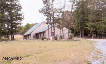 Want complete privacy and serenity? Then this house on 27.5 acres is for you! Private drive leads to this fantastic house, many upscale amenities. Vinyl-sided w/stone accents, lots of windows, hardwood floors, ceiling fans, gas fireplace, chandelier, custom kitchen, cathedral ceilings in great room, dining room doors lead to patio, living room has French Doors. Upstairs has additional 735 sq ft w/partially finished bedroom, full bath, den, bonus room. Beautifully landscaped w/flower beds bordered with stone walls. Yard areas surrounded by woods. Additional large building has 1-car garage, large workshop and full bath, upstairs guest apartment w/kitchen living/dining room, bedroom and full bath.