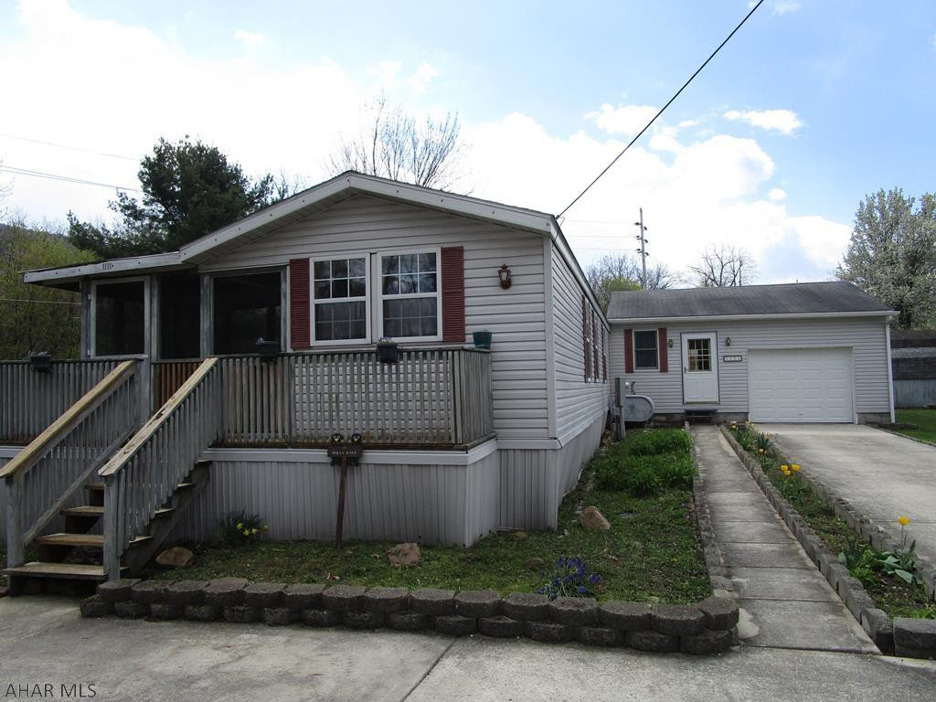 TITLE HAS BEEN RETIRED........Single wide Mobile home w/addition! plus a one car garage.  Sits on little over 1/2 acre of FLAT ground.