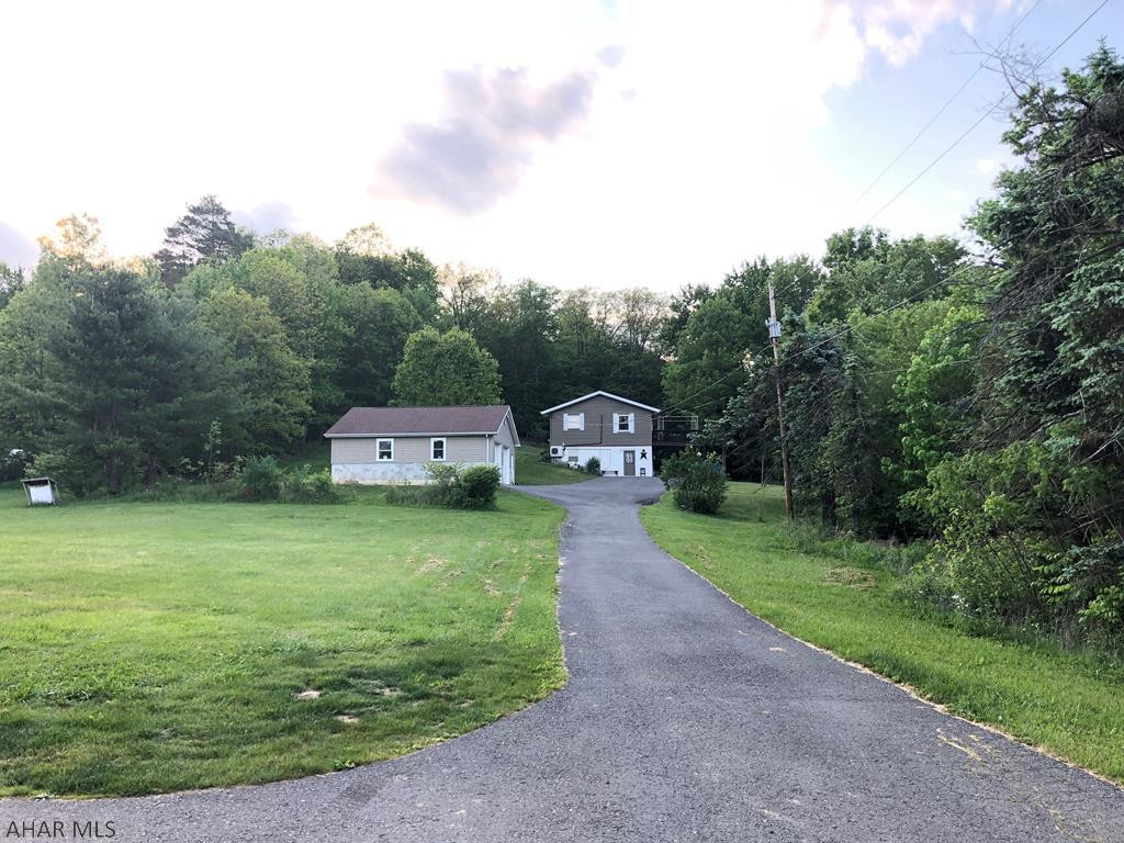 This extremely well maintained and updated property is on a secluded 1 acre lot in Bellwood School District, it has beautiful views, trails and natural wildlife that connect directly to this property.  Great property for entertaining family/friends both inside and out.  The renovated spacious eat it kitchen features a large island, granite counters, and plenty of cabinet storage.  The living room connects to the deck.  It has two spacious bedrooms with plenty of closet space.  The bath on this floor has been updated as well.  The lower level family room is extremely large.  This level also has laundry room and full bathroom.  Large garage has plenty of room for two vehicles and other toys.  Call today!