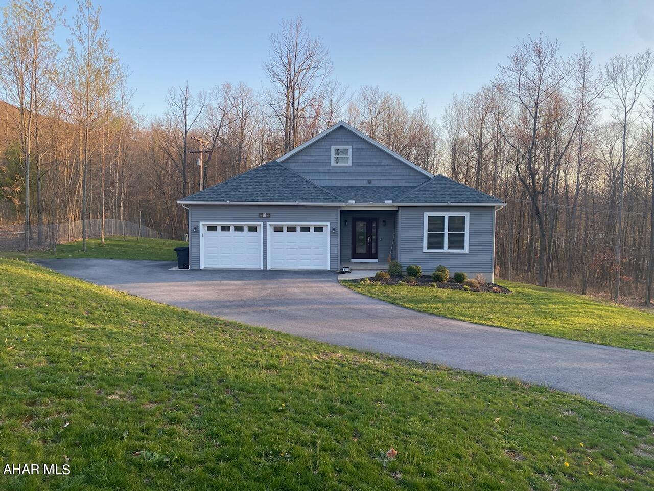 This modern home features an open floor plan with a spacious living room, dining area, and kitchen. The kitchen has modern appliances, stainless steel refrigerator, oven, and dw, as well as granite  countertops and a kitchen island. The living room has  large windows that let in natural light and offer views of the woods. This room also features 4 BR,  three baths and newly renovated basement.