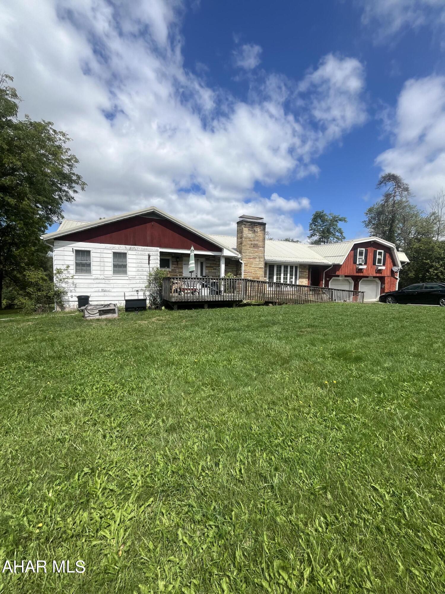 Spacious and unique tudor with lots of possibilities. Home in need of some TLC but offers many amenities like hardwood oak flooring, knotty pine cabinetry, panelling and doors. Stone fireplace and lots of space throughout. Nestled on over 1 1/2 acres in the country! 1BR apartment above garage for extra income.