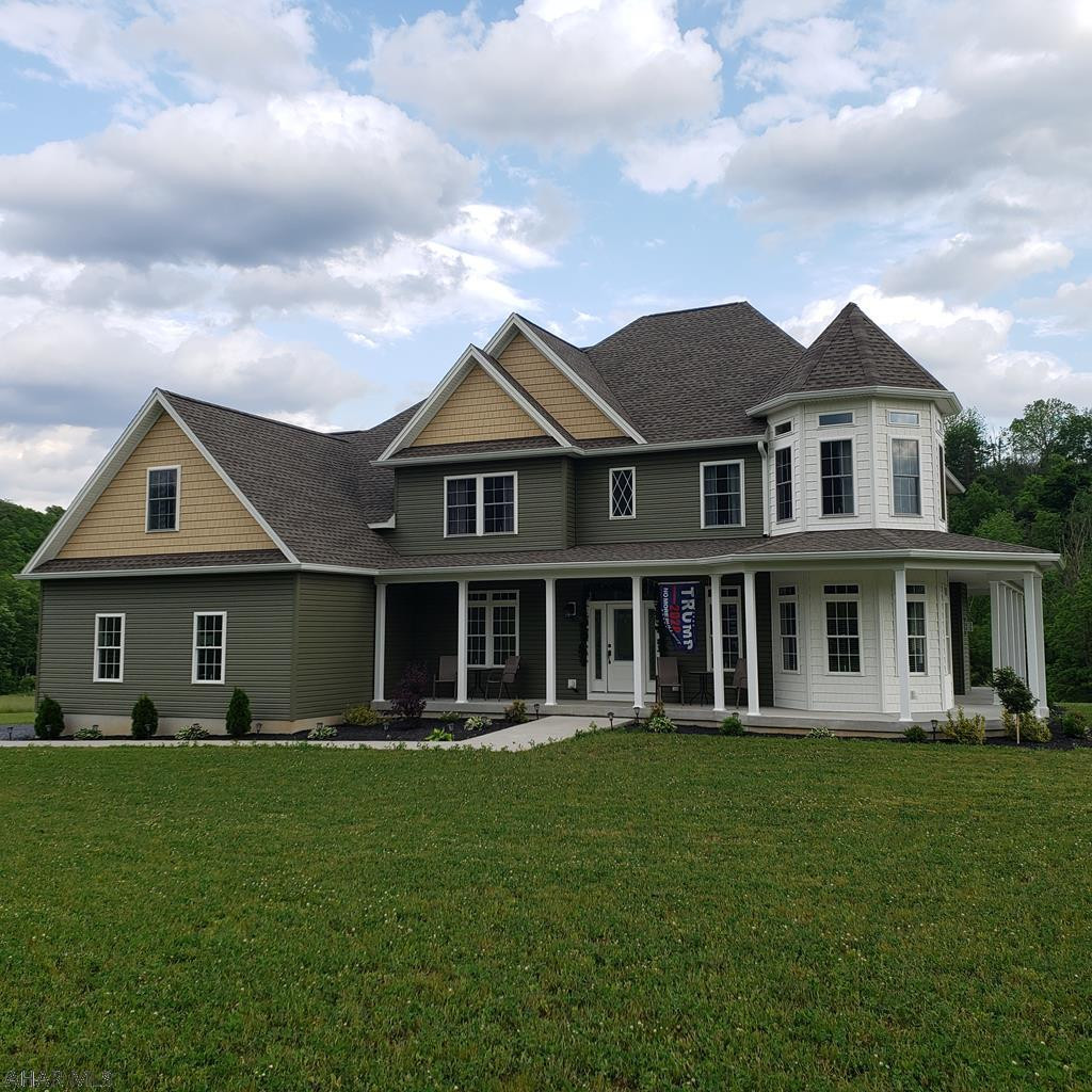 Stunning custom built home in Scotch Valley. This home was built with every detail in mind. Beautiful real Hickory Hardwood flooring  throughout the home, custom blinds, custom kitchen cabinets, granite countertops, wine refrigerator, floor to ceiling stone fireplace, and 2 Bosch high efficiency heat pumps. The first floor feautures an open floor plan along with a formal dining room, first floor bedroom, 3/4 bath, and private study with french doors. The second floor offers two large bedrooms, full bathroom with double sinks and recreation room. The master suite is impressive with a HUGE walk in closet, 6 foot jetted tub with mounted tv, tile flooring double sink and granite. This home sits on just under 3 acres, with heated, attached, oversized 2 car garage & 1 car detached garage.