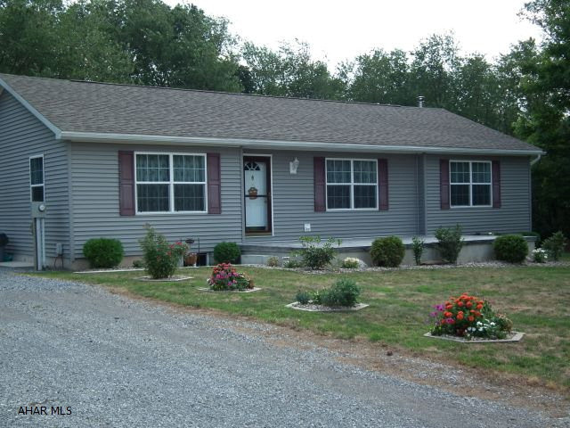 This one story Home offers wooded surroundings on 1+ acre.  Built in 2004 home is like new.  Private Patio in back & newly poured front patio.  Home offers 3 Bedroom, roomy living room - kitchen with eating area & sliding glass doors leading to patio.  See pictures.  Shared maintenance is written into the deed.