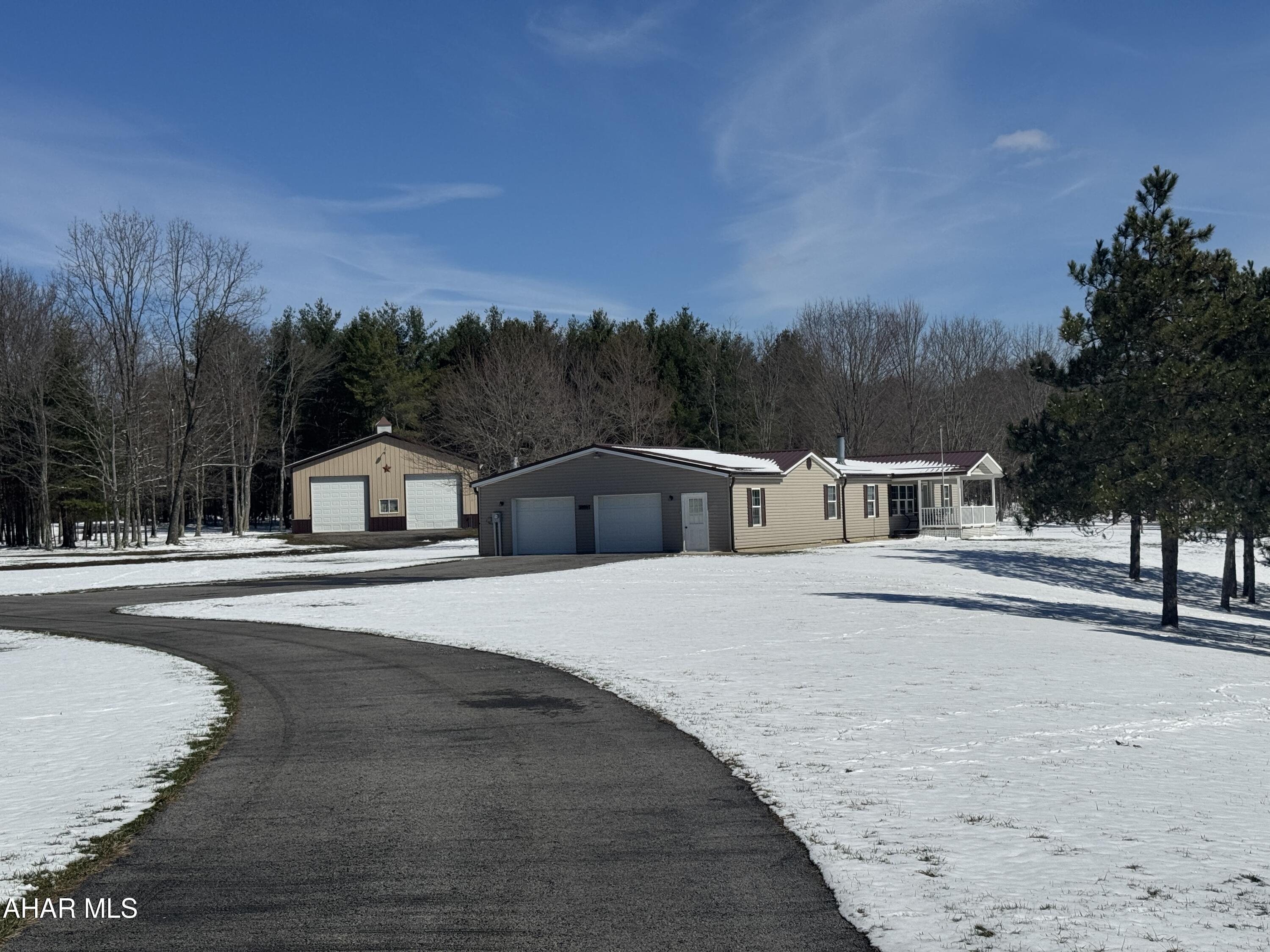Rural paradise - 75.9 acres with a beautiful doublewide on a full basement foundation. The home features 3 bedrooms, 2 full bathrooms, living room with fireplace, eat in kitchen with dining area, laundry room and attached 2.5 car attached garage. There is a partially finished basement. Large pizza oven hooked up for your enjoyment.  Outside there is a large pole garage with concrete floor, 2 ponds and picnic area. Topo is good with both wooded and cleared land. Turkeys and deer feed in the backyard! Remarkable property with lots to offer!
