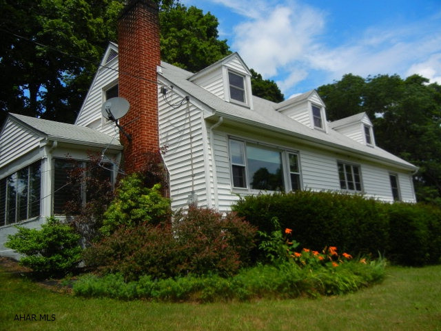 This 3 bed. 2 bath Cape Cod is situated on l.37A with lots of privacy yet minutes from town.  First floor bedrooms and bath. Second floor has new replacement windows. Central air in first floor. Large bonus rm on second floor.  Enclosed side porch. Nice hardwood floors throughout.  Epoxy garage floor. Barn can be used for additional  storage or hobbies.