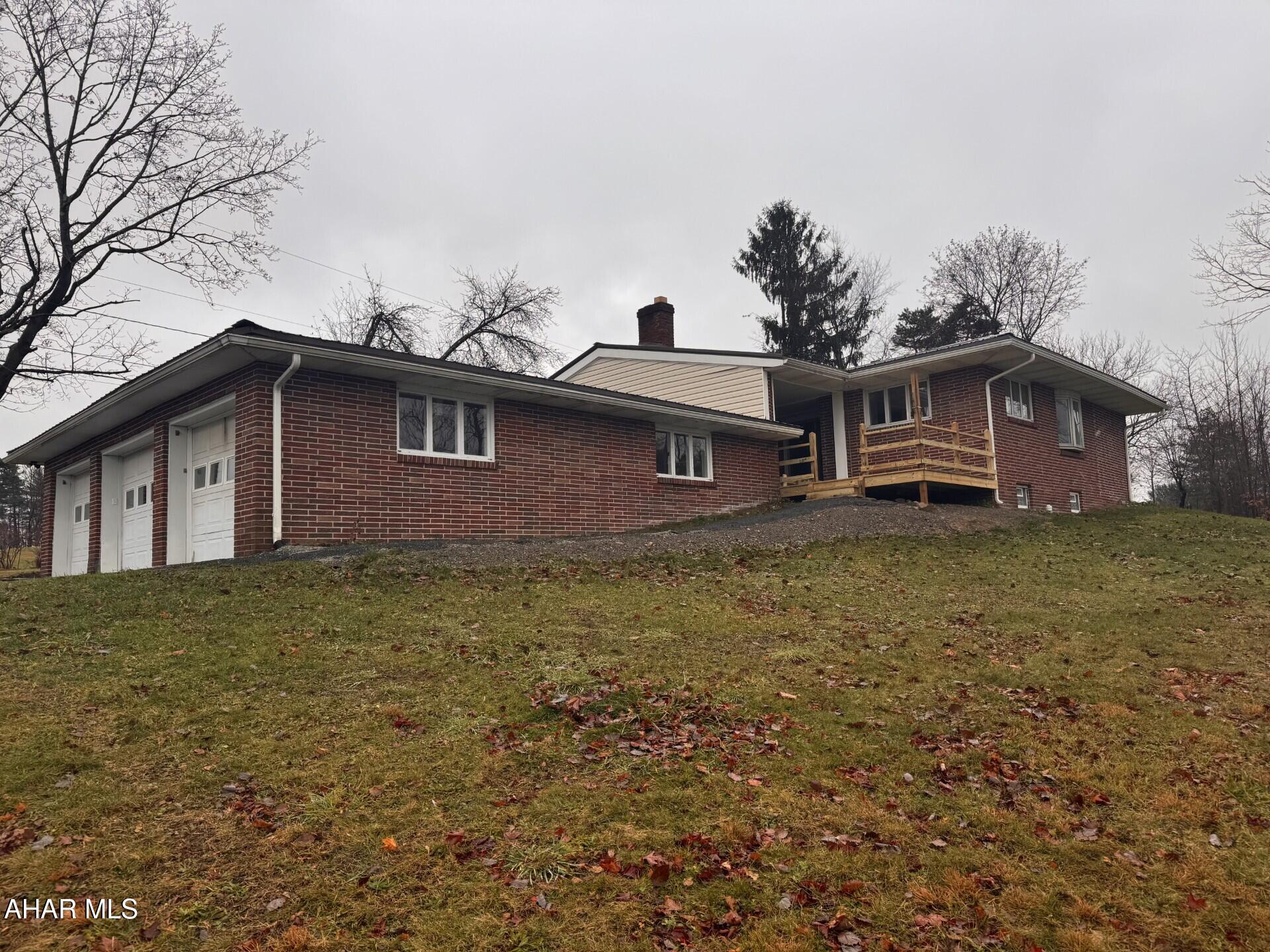 Renovated 3-4 Bedroom, 3 bath brick ranch home on 0.79 acre lot.  Spacious kitchen, LR with woodburning fireplace, Large sunroom area.  Gas, hot water BB heat.  New metal roof.  3 Car attached garage.  Ready to move in!