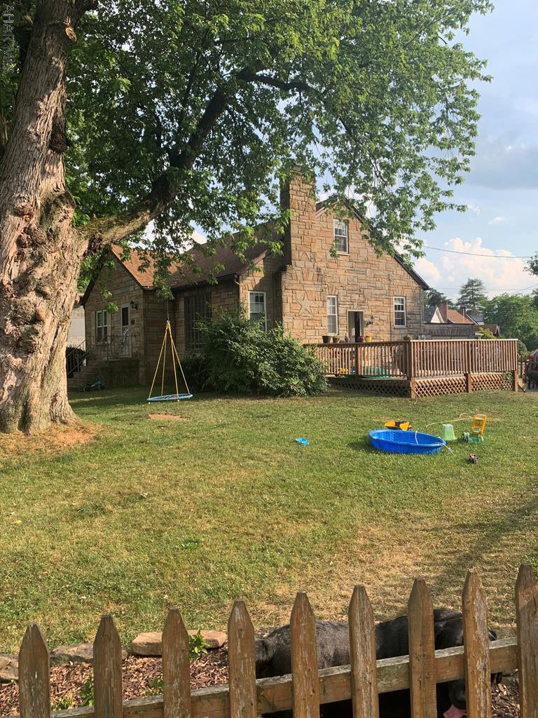 This charming, idyllic stone home is move-in ready. The outside has a fenced in yard with a deck, as well as a bonus yard surrounding the home with a flourishing garden and a very large shed! Walk into an updated kitchen, and into the dining room with gorgeous hardwood floors. Enjoy cozy evenings in the large living room with a working fireplace. Lots of updates in the home such as new flooring, newer furnace, radon mitigation system, and a mini split for extra comfort on the third level! Close to shopping and restaurants, but settled in a quiet area. Schedule your showing today! Extremely Motivated Sellers!!