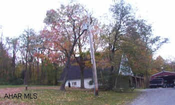 Take Route 36 through Ashville to School House Road on right.  Go 2 miles to Loop Road.  Take right.  Go 1.5 miles to sign on left. Charming  country chalet on 6.3 private and secluded acres.  Beautiful above-ground pool with large deck. Won't last!