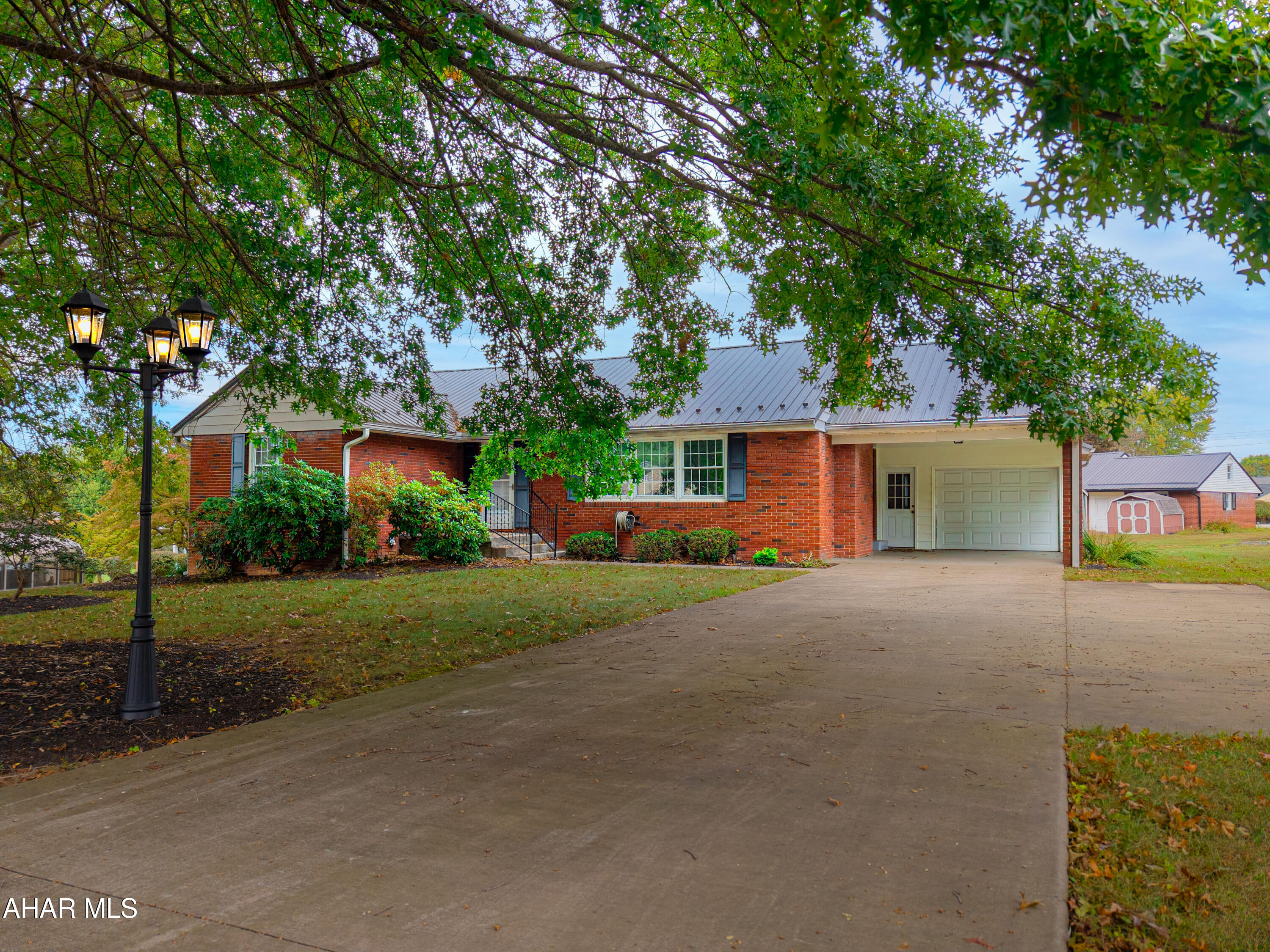 Location, location, location!! Brick ranch home situated in Meadowbrook Terrace! This home features three bedrooms, living room with wood burning fireplace, dining room, kitchen, sunroom, and one- and one-half baths on the main level. Full walk-up attic with room for all your storage. Full basement that is partially finished with a family room, full bathroom and a laundry room. Unfinished bonus area for more storage. One-car attached garage, and one-car carport. Concrete driveway and a storage shed in the rear yard. Oil hot water heat, heat pump with central air, replacement windows, 200-ampere electric, and a metal roof. Solid brick home that was well built. With some updating on the interior, this could be a beautiful home.  Convenient location to schools, downtown Bedford, restaurants, and shops.