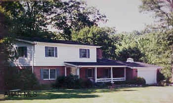 2 story, brick and cedar, 3 bedrooms, 2.5 bath.  2 family rooms 2 kitchens Beautiful 3 bd, 2.5 baths.  Plaster walls, family room w/FP on first floor.  Solid cherry cabinets w/korian tile counter top in kitchen.  Finished basement w/FR.  Kitchen ceramic floors, 3/4 bath.  2 garages, 3.90 acres.